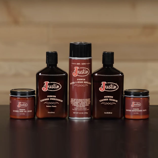 Shoe care products including leather conditioner, water and stain repellent spray, leather cleaner, and leather: mink and oil cream placed on a table. 